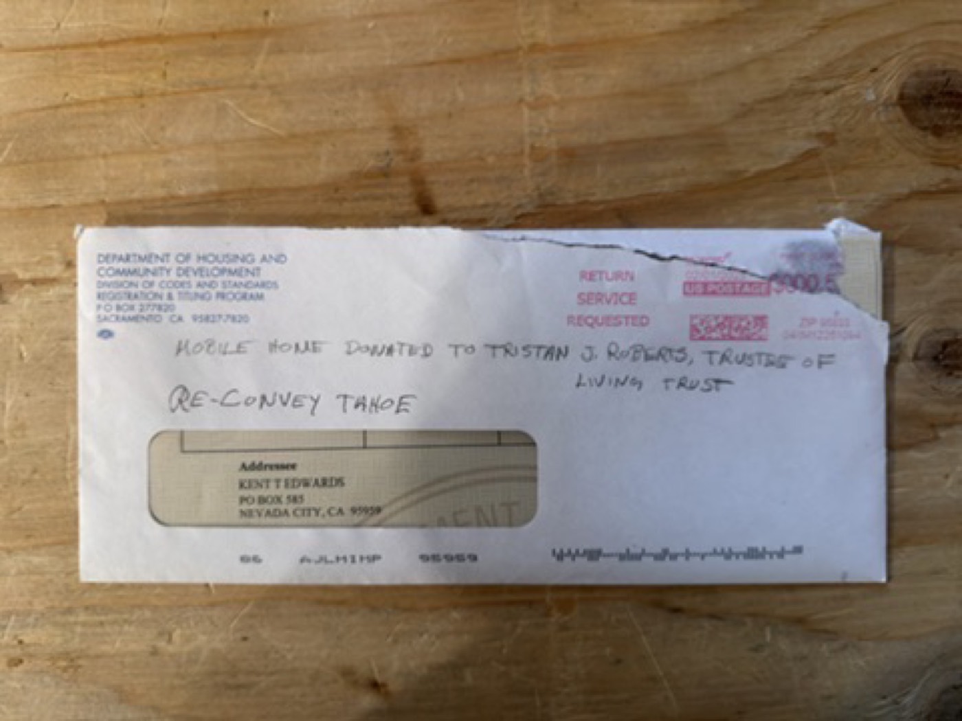DHCD envelope with handwritten mobile home donation note